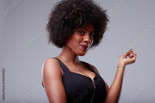 Cute young Black woman giving the camera a charismatic grin photo