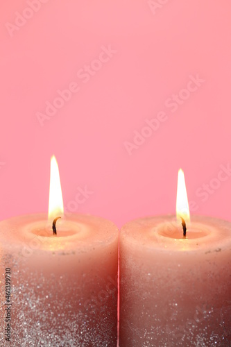 Candles set. Burning candles on a pink background. Festive shiny candles. Flame candles .Religion and culture