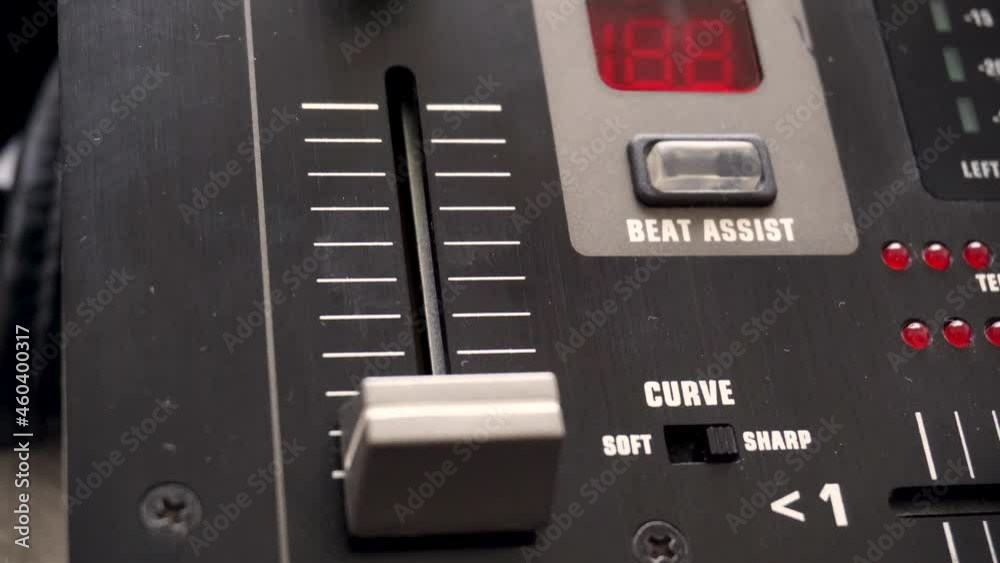 Close-up of fingers lowering a fader on the mixing console Close-up of fingers lowering a fader on the mixing console