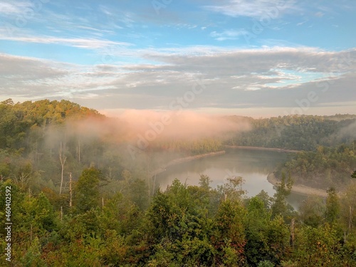 Sky with clouds and fog over a river in the distance.