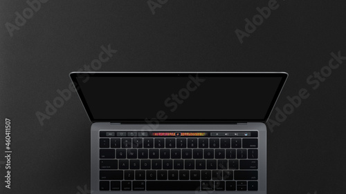 Laptop on dark background top view shot with space for text