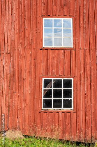 Red wall with white windows on a barn