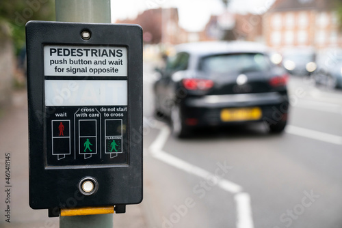 Pedestrains push button and wait for signal opposite at crosswalk, Traffic light at square in urban or city photo