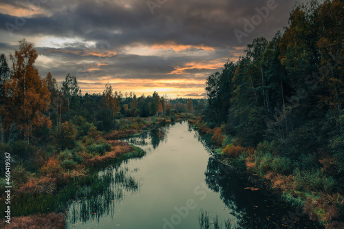 Sunset over the river in autumn
