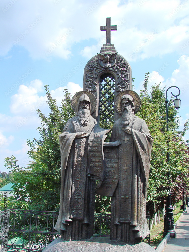 Fototapeta premium Immortalized view of the saints on the most painted place of Kyiv under the Orthodox cross on the doves of peace.