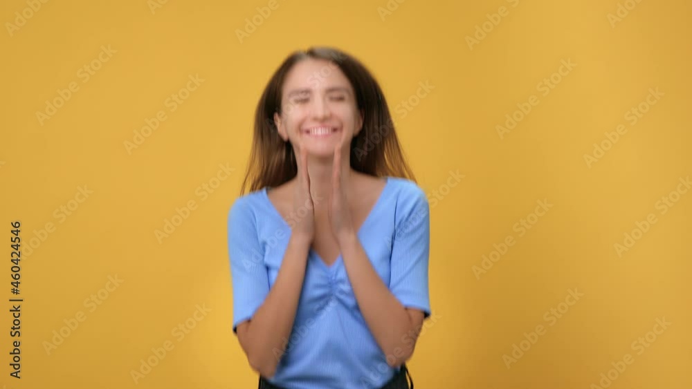 Portrait of happy woman jumping with crossed fingers celebrating success isolated on orange studio Portrait of happy woman jumping with crossed fingers celebrating success isolated on orange studio
