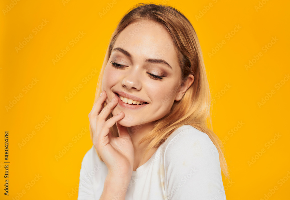 beautiful blonde in a white positive posing joy smile Studio Model close-up beautiful blonde in a white positive posing joy smile Studio Model close-up