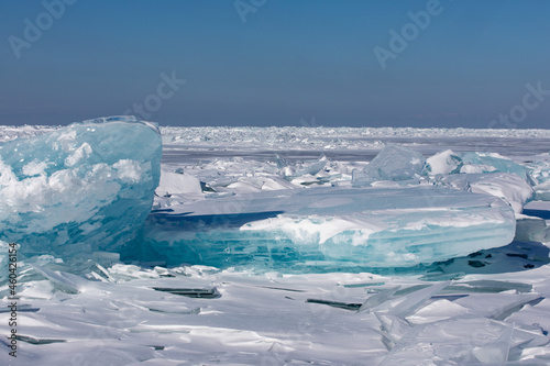 Gremyachinsk, Baikal, Russia February 10, 2019. Texture ice landscape on winter snow-covered Baikal. Ice hummocks. The purest ice of Baikal. photo