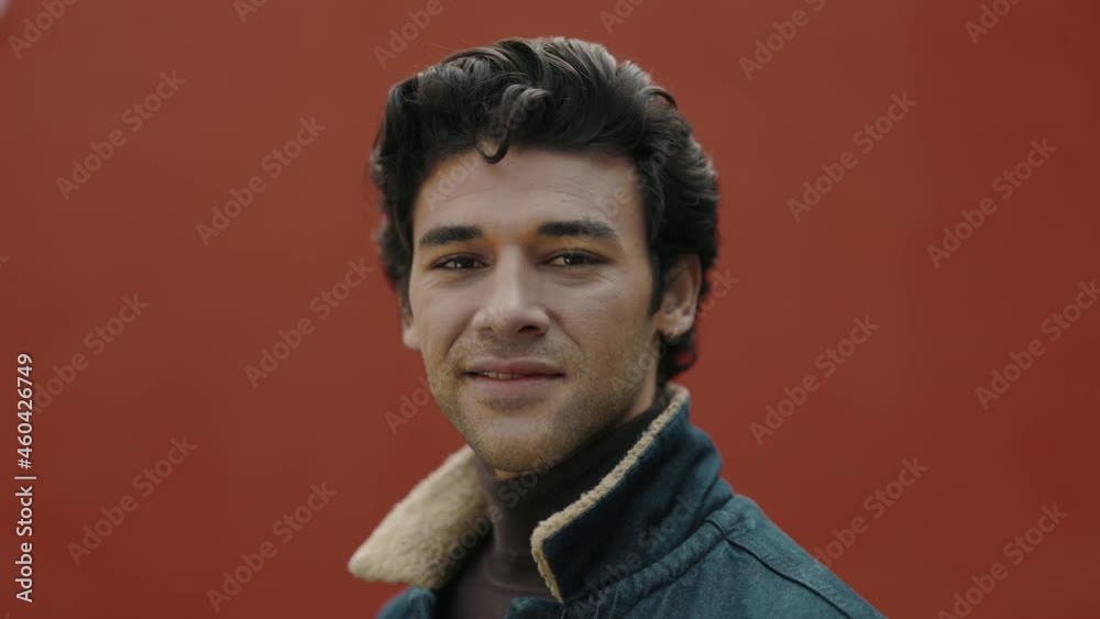 Arabian guy standing on street and smiling on camera Arabian guy standing on street and smiling on camera