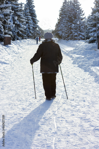 Senior at the snow in winter nordic walking © Ankomun