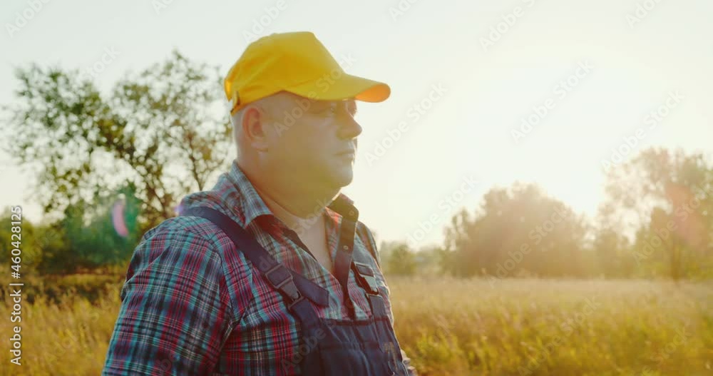 Portrait of a male farmer in a wheat field. The concept of agriculture, harvest, farming. Portrait of a male farmer in a wheat field. The concept of agriculture, harvest, farming.