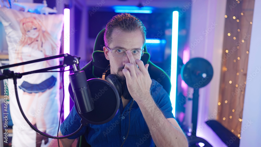 Fototapeta premium Confident male gamer put on glasses with middle finger and get ready to play