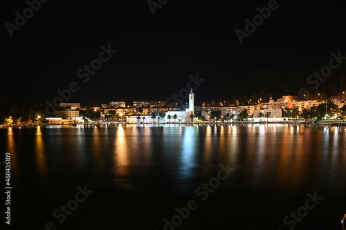 City of Ploce and Adriatic sea in Croatia by night. Panoramic view of  buildings in town reflected in the water.  © Ajdin Kamber
