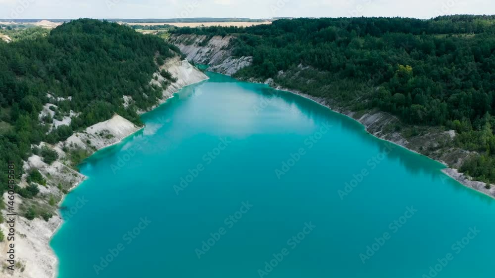 Drone view of open cast mine. Earthmoving work in open pit mining. Turquoise background of the water in chalk quarry. Industrial landscape. Aerial view Drone view of open cast mine. Earthmoving work in open pit mining. Turquoise background of the water in chalk quarry. Industrial landscape. Aerial view