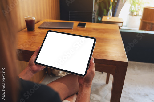 Mockup image of a woman holding digital tablet with blank white desktop screen © Farknot Architect