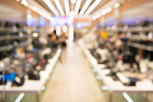 Interior of outlet shop in shoes section as blurred store background