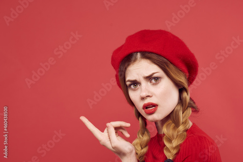 pretty woman in a red sweater cosmetics emotion studio posing