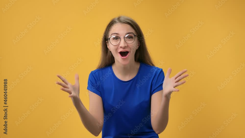 Closeup portrait shocked woman in eyeglasses shouting wow having surprise isolated on orange studio