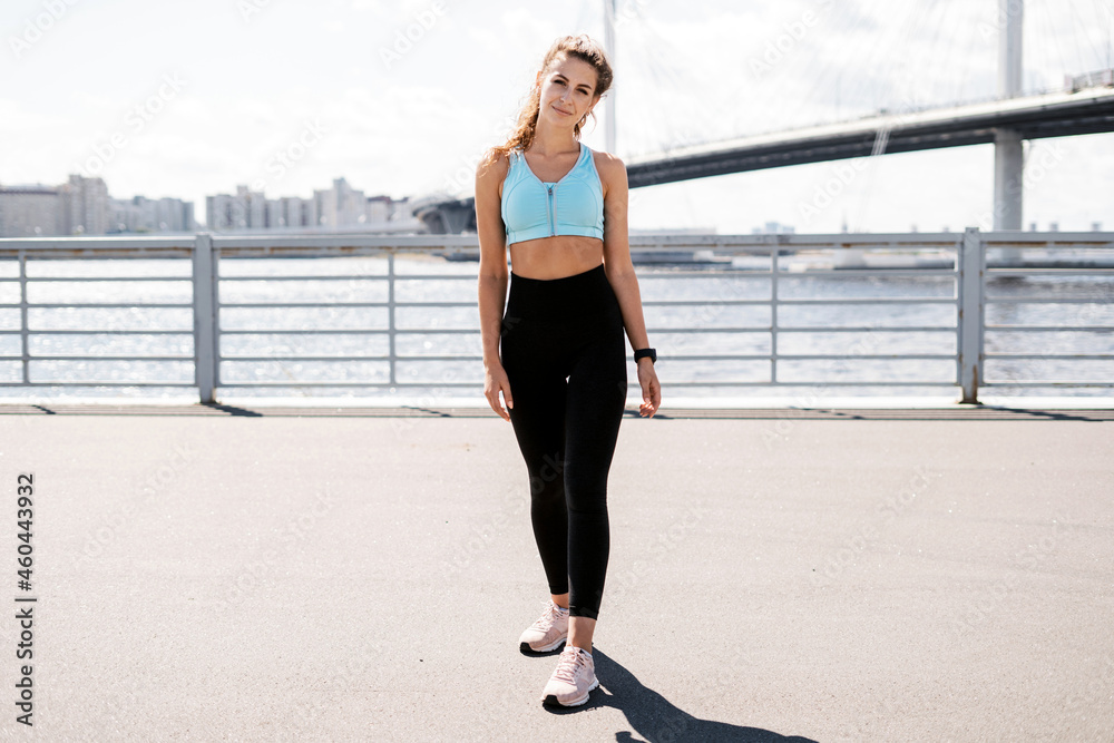 Fitness break in the city. Cardio training for weight loss. The athlete leads a healthy lifestyle. The trainer counts the pulse on a smart watch. Sports and clothing for women. Fitness break in the city. Cardio training for weight loss. The athlete leads a healthy lifestyle. The trainer counts the pulse on a smart watch. Sports and clothing for women.