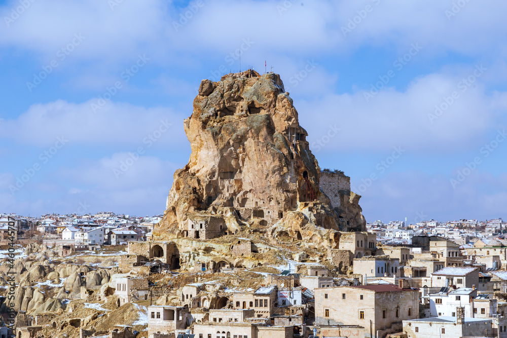 Volcanic rock landscape of Fairy tale chimneys in Cappadocia with blue sky on background in Ortahisar. Fortress, castle in the city of Orta Hisar