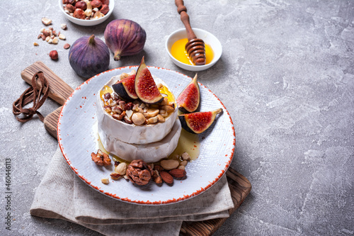 Brie or camembert cheese with fresh figs, nuts and honey