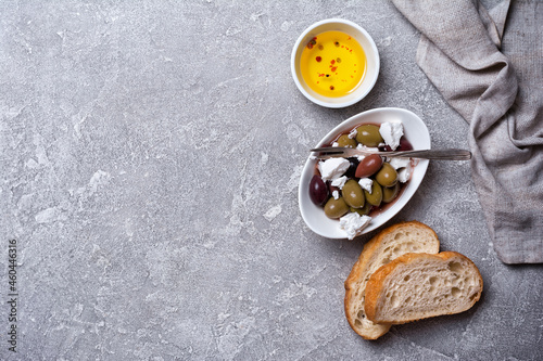 Bowl of delicious olives with Feta cheese and bread
