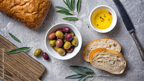 Bowl of delicious olives with oil and bread