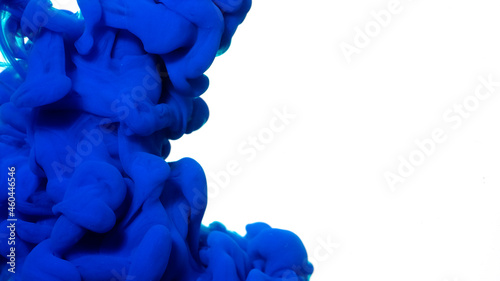 Blue watercolor ink in water on a white background. Blue cloud of ink on a white background. Abstract background. Drops of blue ink in water.