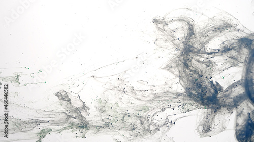 Fototapeta Naklejka Na Ścianę i Meble -  Blue watercolor ink in water on a white background. Blue cloud of ink on a white background. Abstract background. Drops of blue ink in water.
