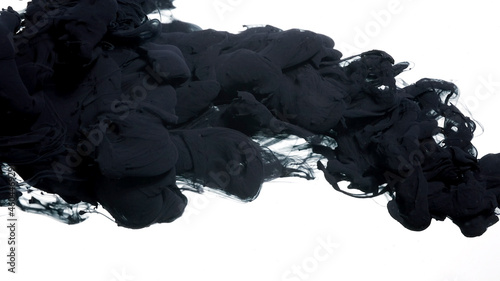 Black cloud of ink on a white background. Abstract background. Drops of black ink in water. Colored acrylic paints in water.