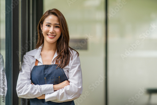 Beautiful young woman portrait. Smiling businesswoman with crossed arms.