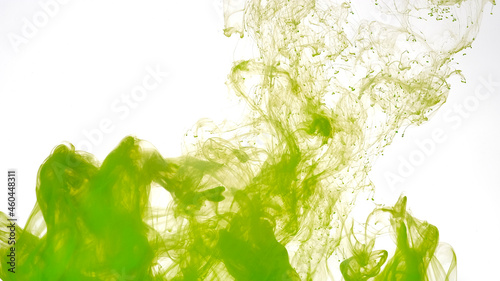 Beautiful abstract background. Green paints are mixed in water. Green watercolor ink in water on a white background.
