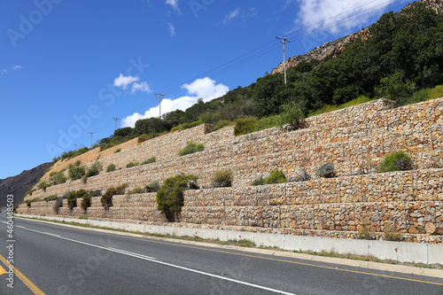 A gabion retaining wall next to a roadway  that runs through the farming community of De Doorns in the Western Cape Province in South Africa. photo