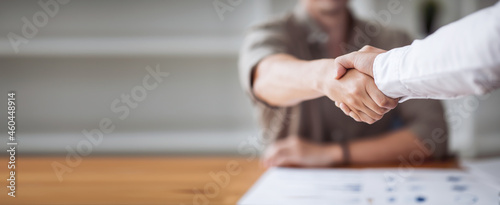 Fotografie, Obraz Close up of two businesspeople shaking hands after a deal contract is done