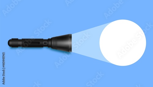 Flashlight with light on blue surface. Realistic black pocket device illuminates