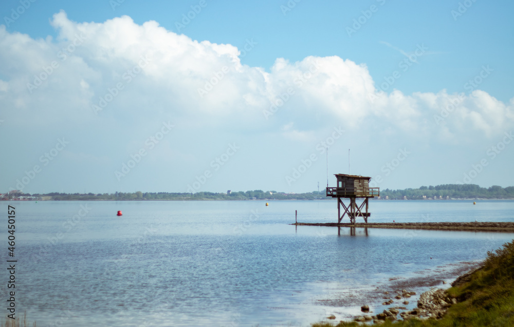 water tower on pier over lake