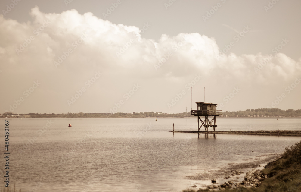 water tower on pier over lake