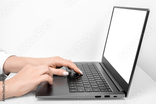Business woman hands using mockup laptop with white blank screen. side view. hand woman work using laptop with white background for advertising,contact business search information