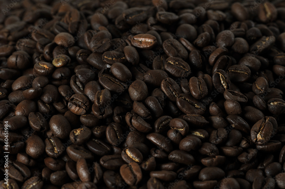 Naklejka premium coffee beans - freshly roasted beans close-up photo
