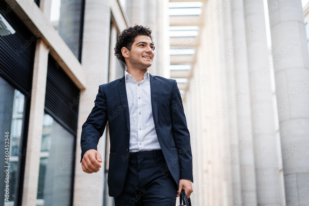 A businessman man goes to a work meeting with colleagues. The entrepreneur financier is dressed in a business suit. The manager responds to the client by email. Business concept. A businessman man goes to a work meeting with colleagues. The entrepreneur financier is dressed in a business suit. The manager responds to the client by email. Business concept.