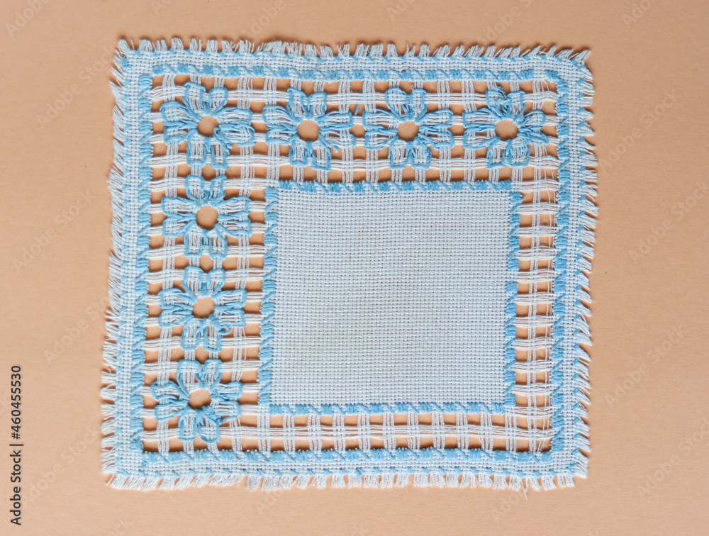 The original blue napkin with handmade blue flowers embroidered on it. The original blue napkin with handmade blue flowers embroidered on it.
