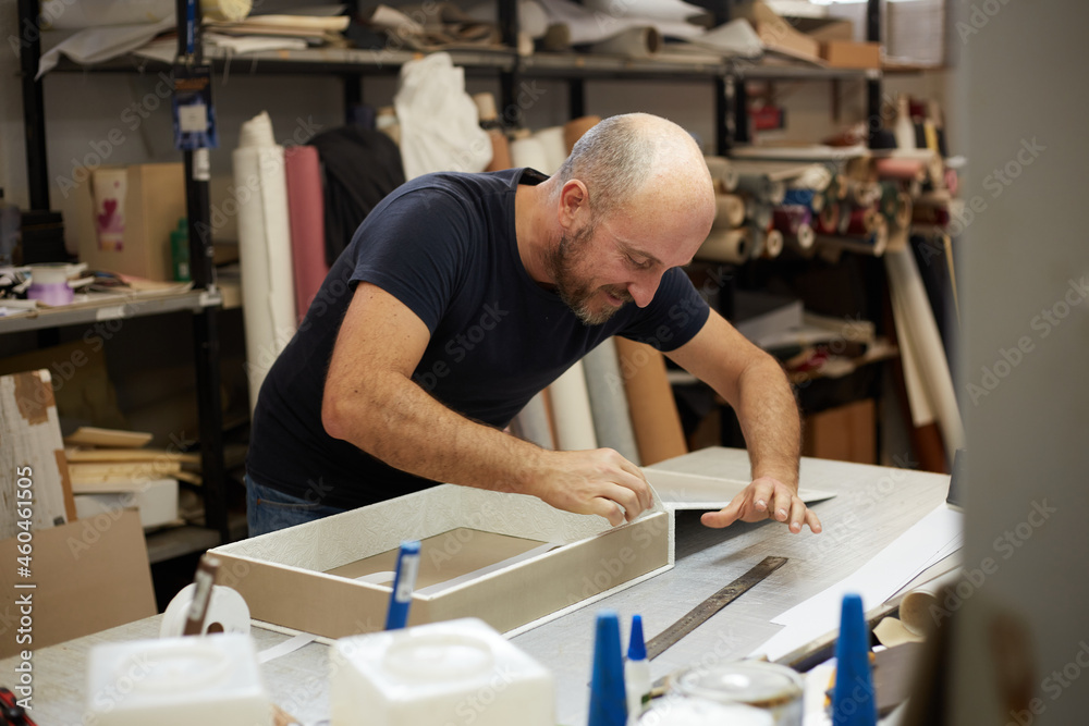 book binder working in a workshop book binder working in a workshop