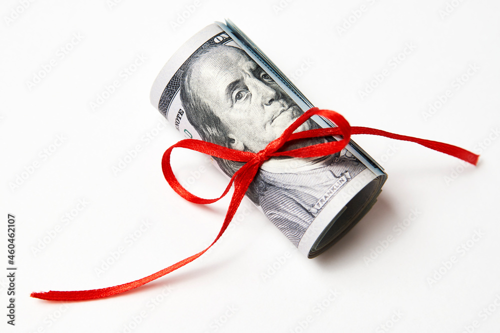Dollar money with red ribbon on white background Dollar money with red ribbon on white background