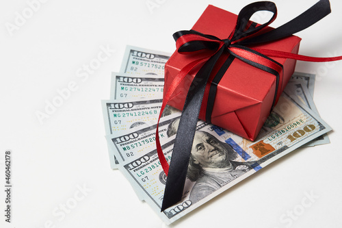 Gift box with dollar banknotes on white background