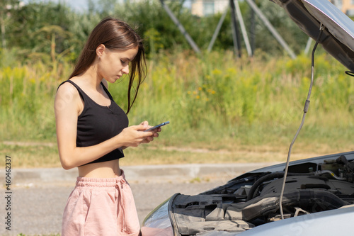 car problems,woman with a broken auto on the road,help is called by phone