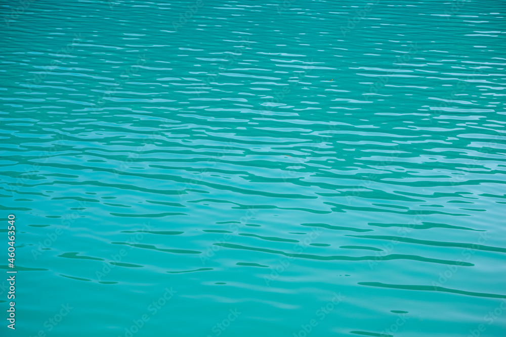 Turquoise water surface with light waves as a texture or background Turquoise water surface with light waves as a texture or background