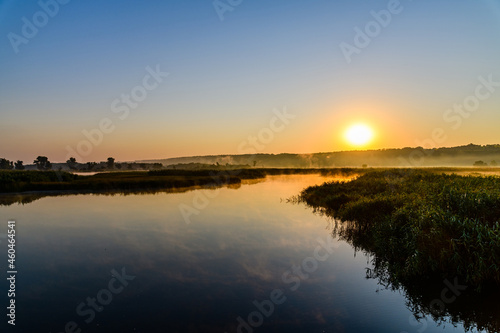 Fototapeta Naklejka Na Ścianę i Meble -  Fog above the water surface. Sunrise at river