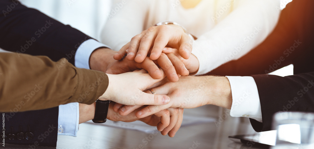 Business people group showing teamwork and joining hands or giving five in sunny office. Unknown businessman and women making circle with their hands Business people group showing teamwork and joining hands or giving five in sunny office. Unknown businessman and women making circle with their hands