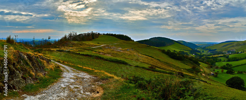 An ancient trackway that is part of the black graded Syfydrin MTB trail from the Nant yr Arian visitor centre. The valley is called Cwmerfyn, the last peak on the left is an iron age hill fort. photo
