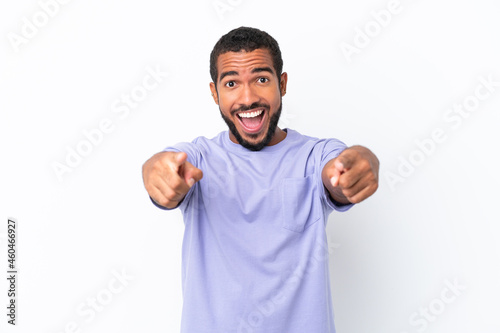 Young Ecuadorian man isolated on white background surprised and pointing front